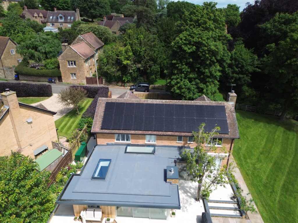 Bird's eye view of a solar panel installation on the roof of a detached house