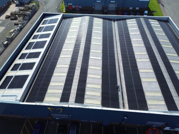 Large-scale solar panel installation on a warehouse roof