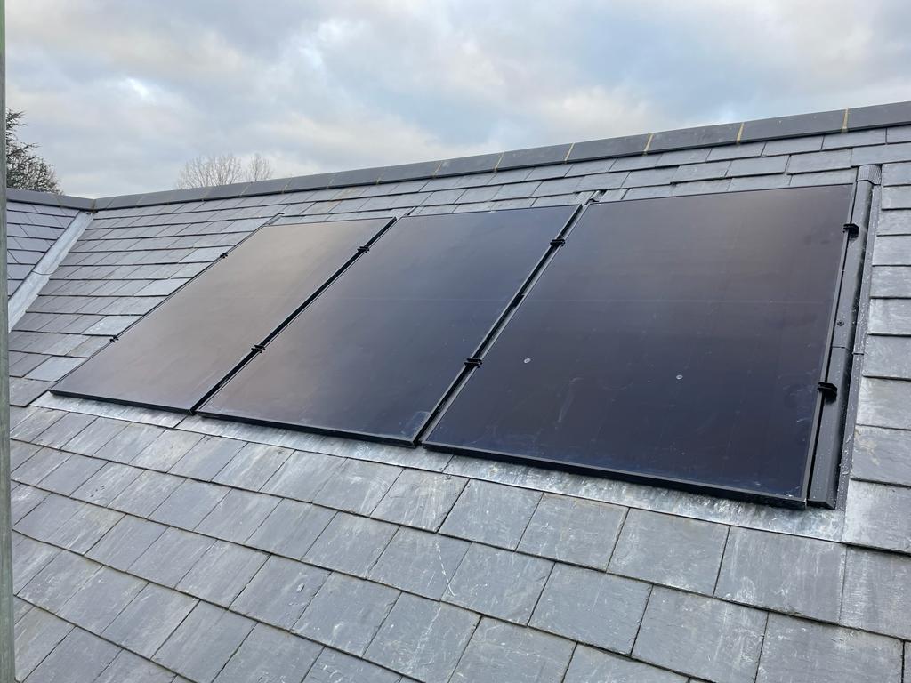 Solar panels on the roof of a detached house in Warwickshire