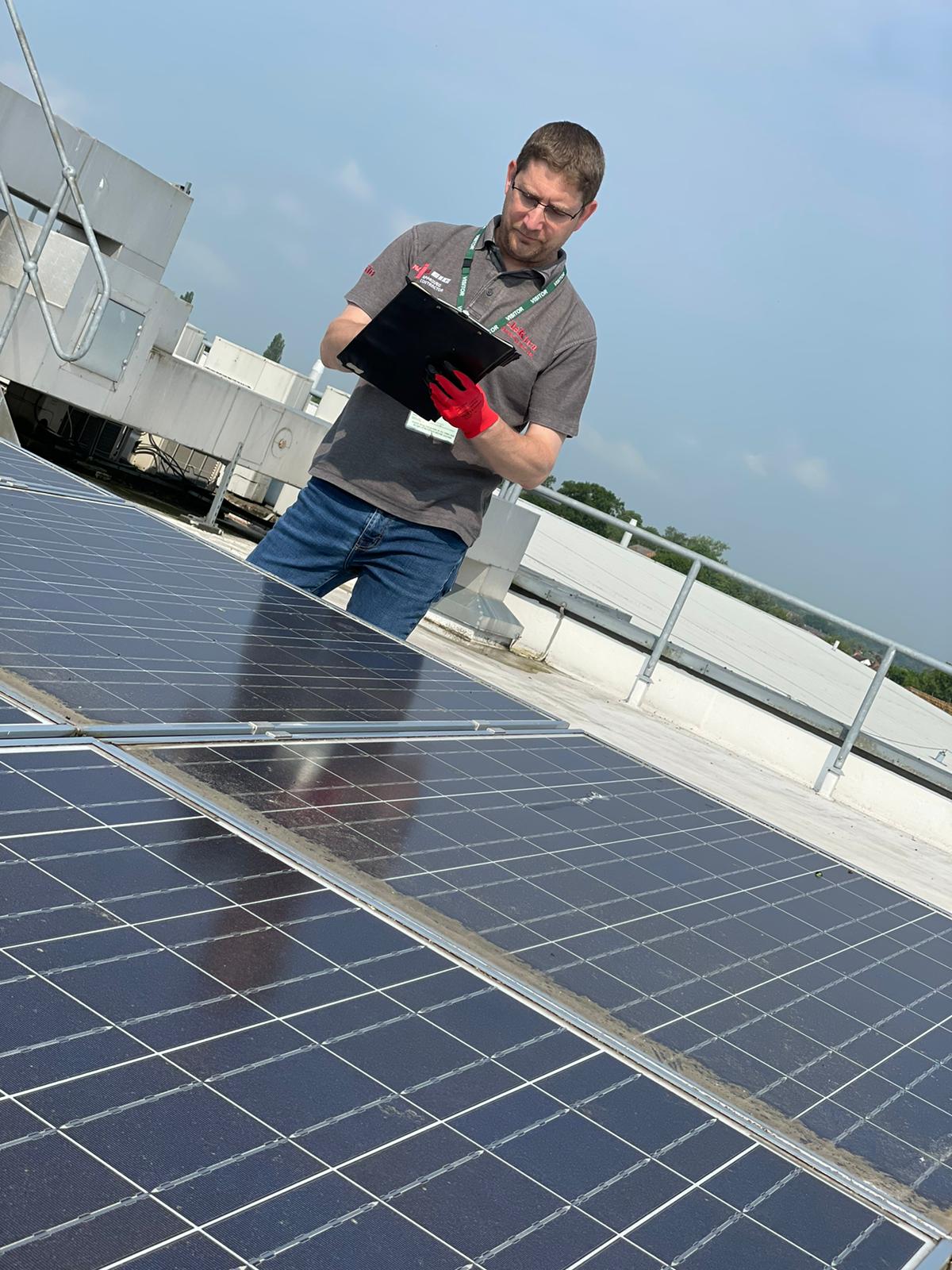 Engineer inspecting commercial solar panels in Stratford-upon-Avon