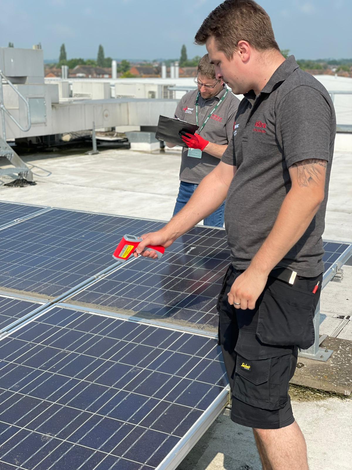 Engineering taking solar panel measurements at a commercial property in Stratford-upon-Avon