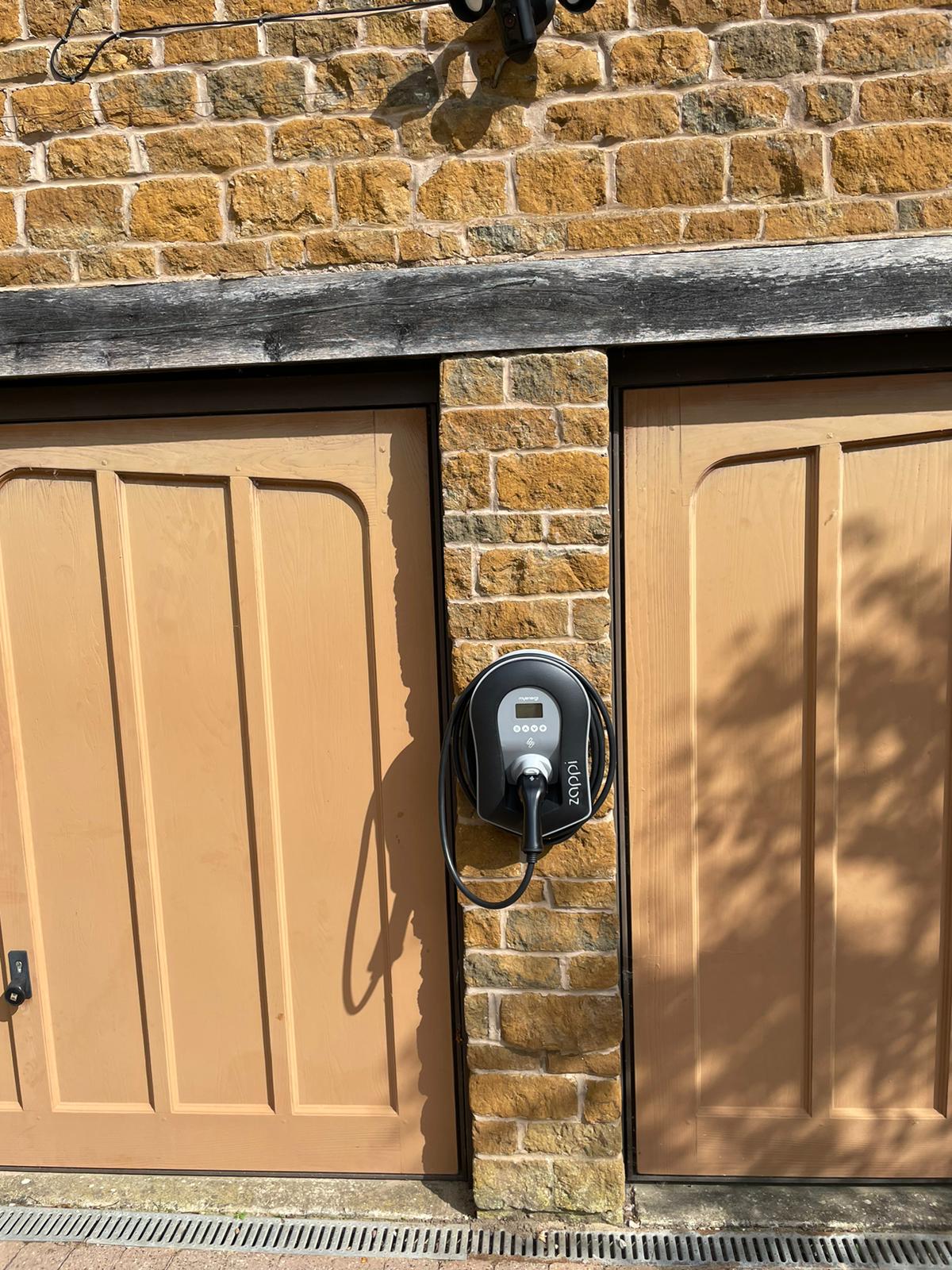 Electrical vehicle charger installed in front of residential garages