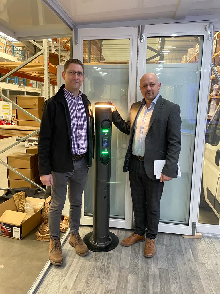 Engineer Mike Neath on a site visit for a commercial EV charger inspection, accompanied by a customer